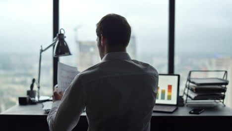 Businessman-reading-documents-at-office.-Professional-celebrating-victory