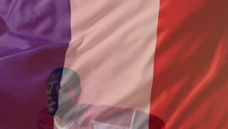 animation of african american male soccer player over flag of france