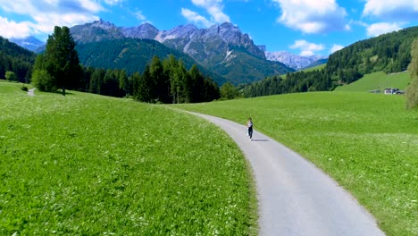 woman jogging outdoors. italy dolomites alps
