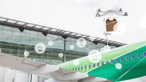 Animation-of-connected-icons,-drone-carrying-cardboard-box,-parked-airplane-in-airport