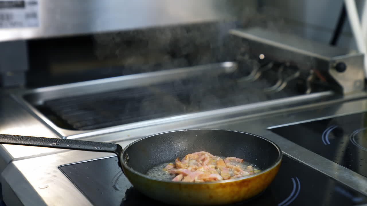 Frying pan at restaurant kitchen. Professional chef cooking food at kitchen of restaurant