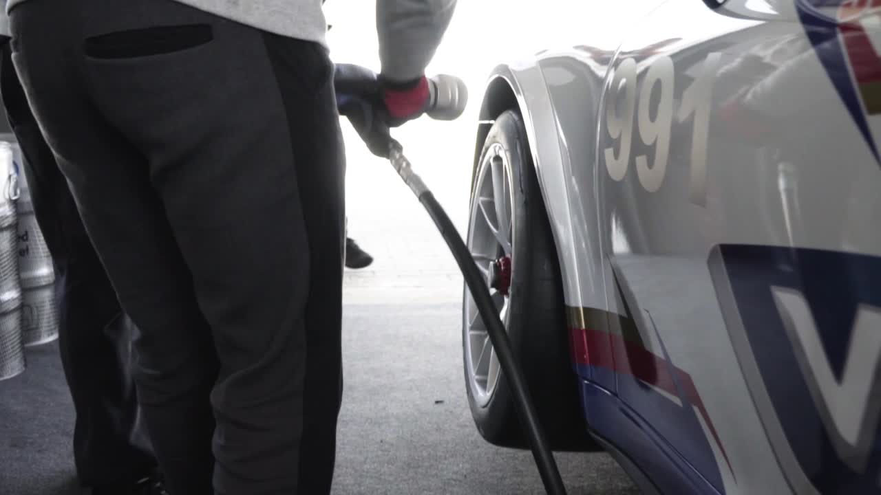 the gunner tightens the wheel nuts pit stop changing wheel in slow motion