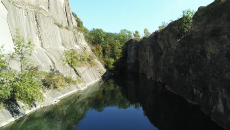 Drone-Flight-Aerial-Over-A-Mountain-Lake,-A-Hidden-Lake-in-Prague,-prokopské-jezírko