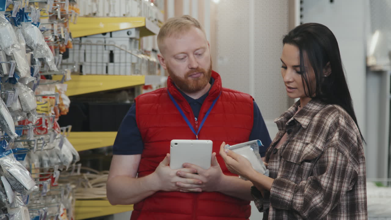 Employee Helping Customer Choose Supplies at Hardware Store