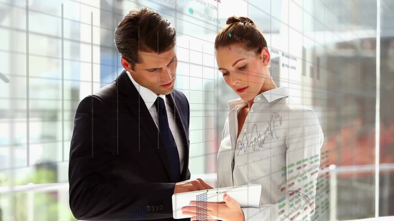 Analyzing financial data, business professionals using tablet with animation overlay