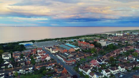 aerial view of a coastal town and beach at dusk or dawn