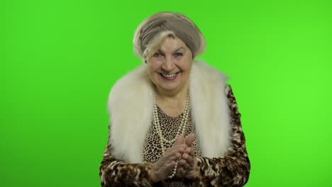 elderly stylish grandmother. caucasian woman claps her hands. chroma key