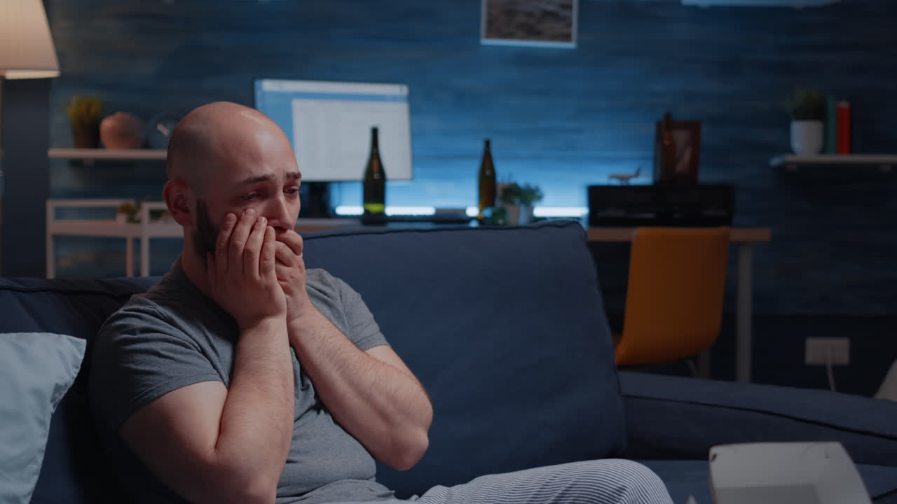 Close up of shocked man dropping phone after hearing horible