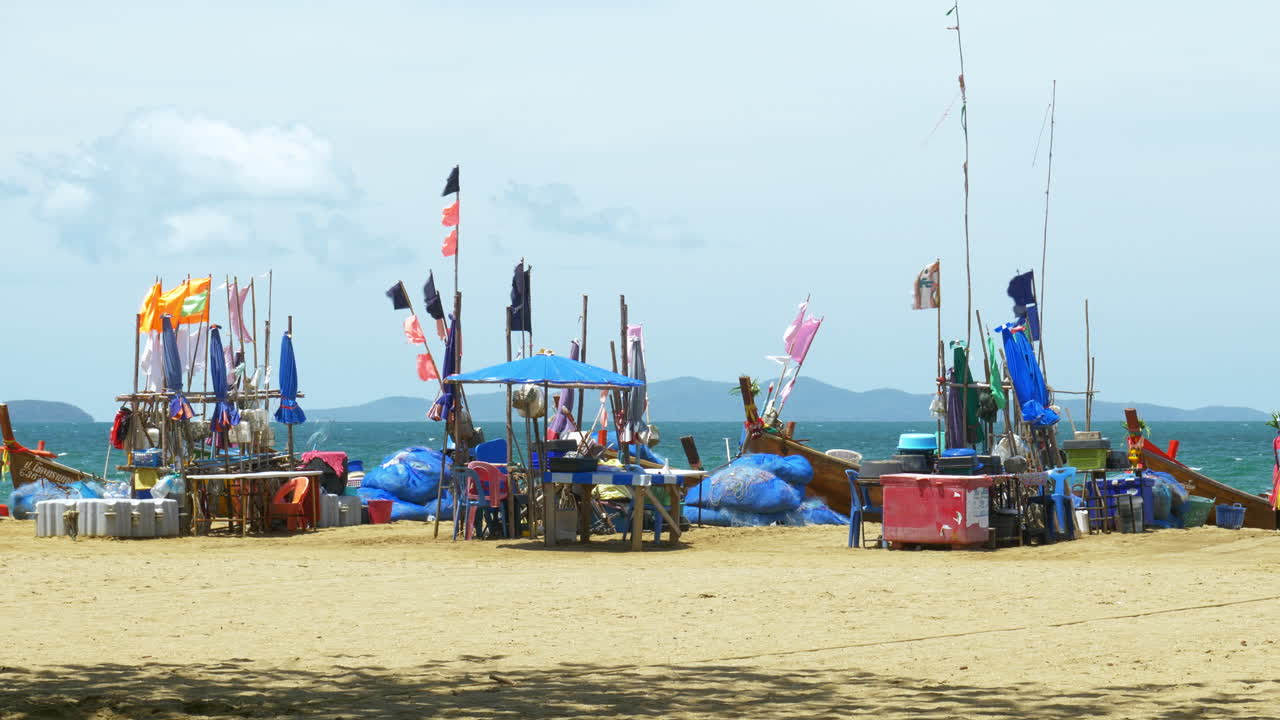 A fishing area in Pattaya where fishermen gather with their fishing boats, nets, and other equipment like ice boxes, tables, and chairs for sorting their catch for the day, in Chonburi, Thailand