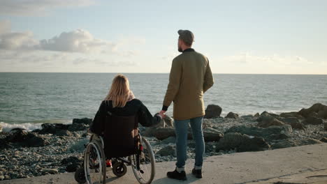 couple at the beach, supporting each other