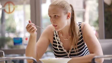 young woman eating spaghetti