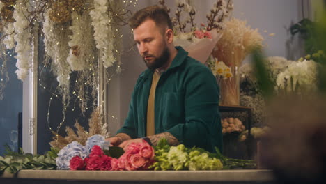 florist prepares beautiful bouquet for sale