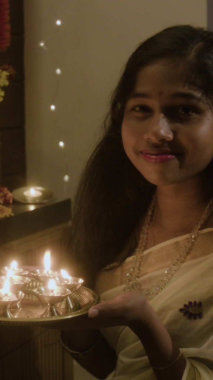 Woman holding oil lamps