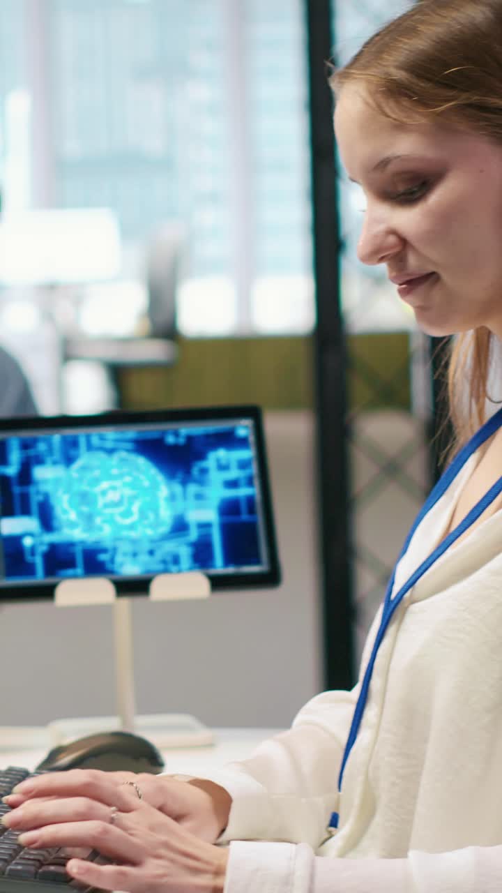 Vertical video Junior dev in office relies on AI tech to run tasks across multiple devices