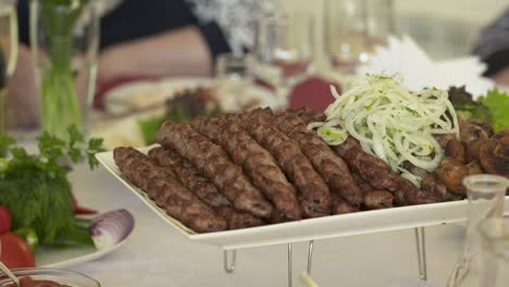 dinner table served with lula kebabs and fresh vegetables