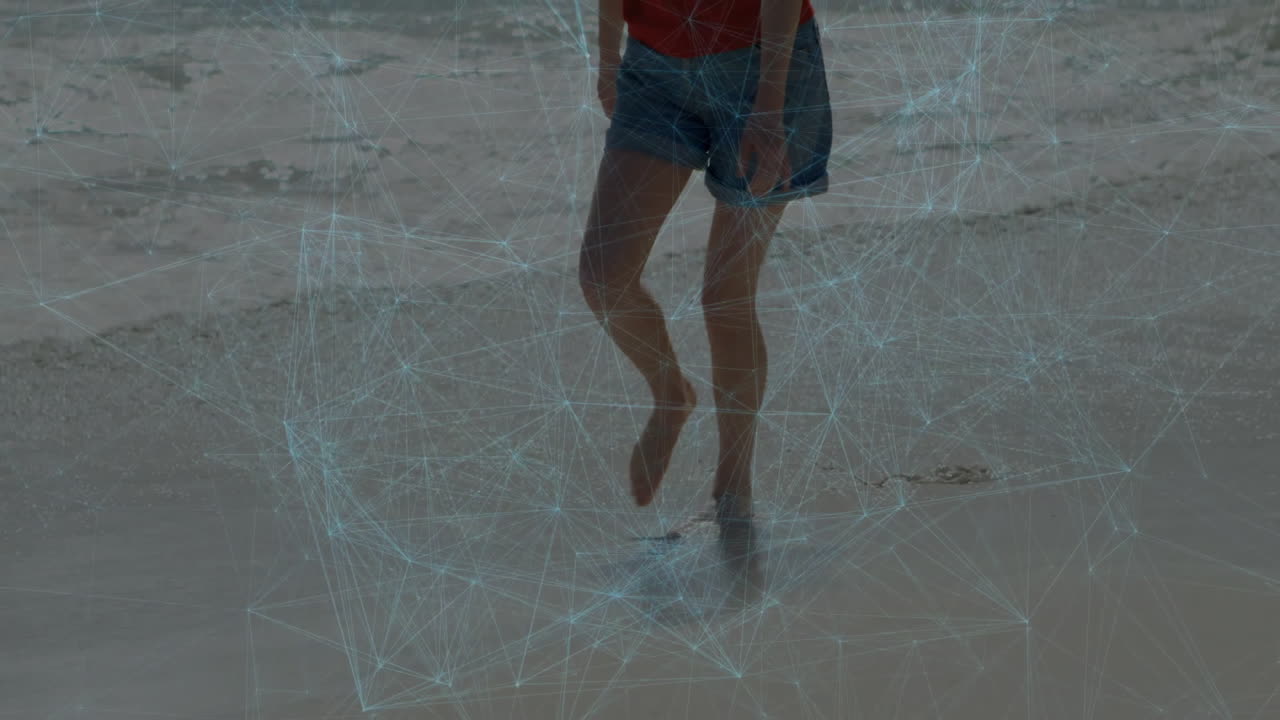 Walking on beach, person surrounded by digital network animation overlay