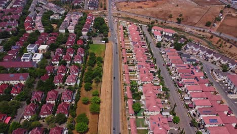 beautiful aerial of traffic driving through a wealthy suburban neighborhood in abuja, nigeria