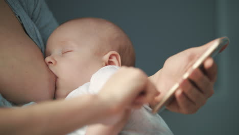 breastfeeding mother using mobile phone