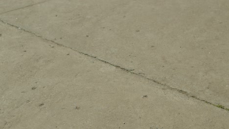 close shot of a soccer player kicking the ball on cement