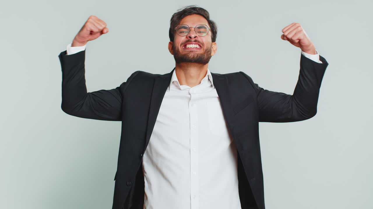 Businessman looking confident showing biceps feeling power strength to fight for rights success win
