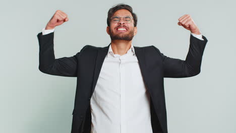 businessman looking confident showing biceps feeling power strength to fight for rights success win