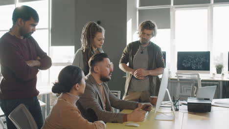 manager talking to team of businesspeople in office