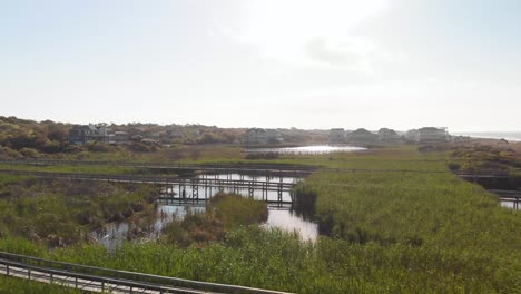 4k-drone-flight-over-dunes-and-piers-in-Oak-Island-NC