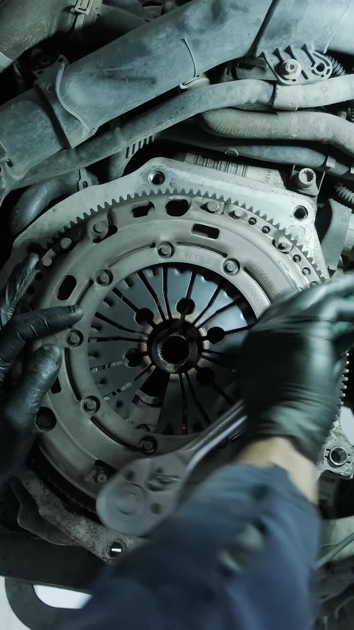 Mechanic Tightening Bolts on a Car Clutch Assembly