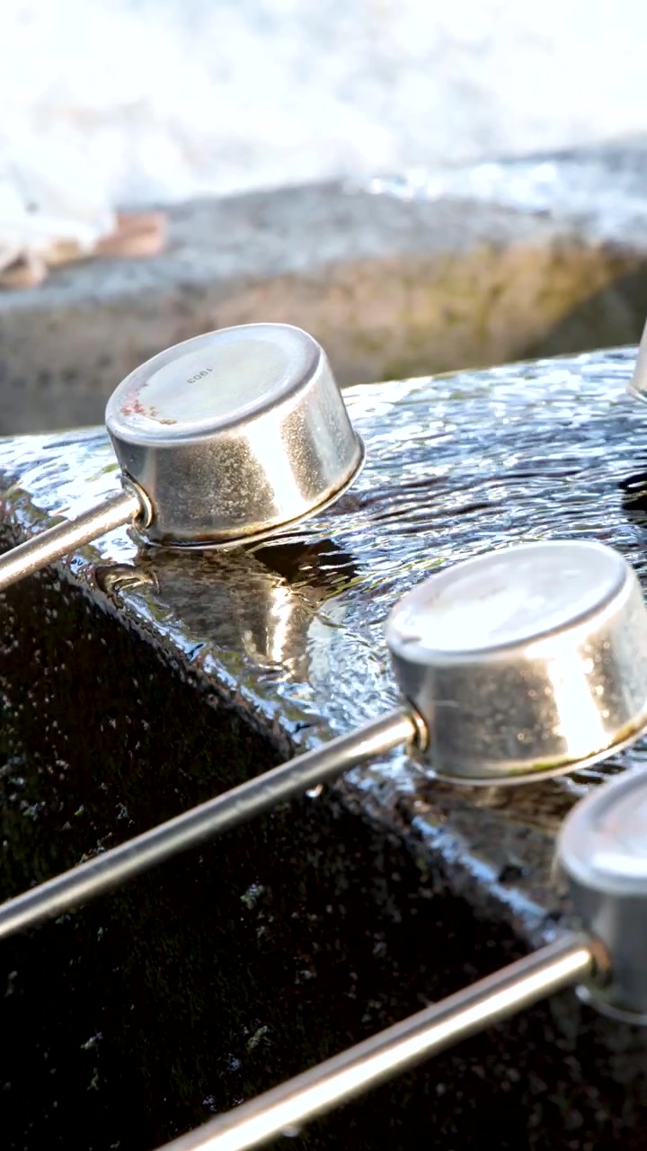 Traditional Japanese Purification Fountain with Flowing Water and Ladles