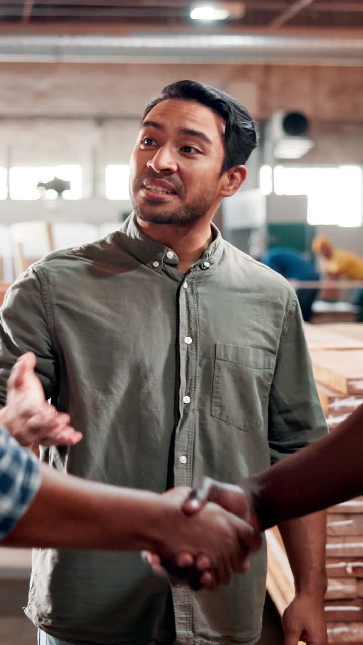 Two Men Shaking Hands and Talking in a Workshop