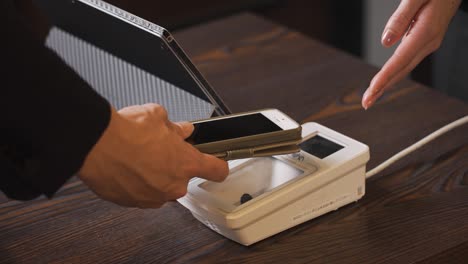 hands of men making cashless payments