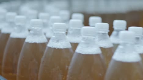 conveyor belt with bottles for juice or water at a modern beverage plant. modern production of sweet soda water