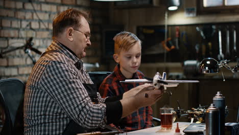 grandfather and grandson building a model airplane