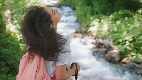 woman hiking by a mountain stream