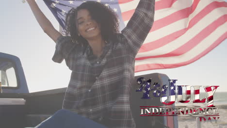 young biracial holding us flag with independence date foreground