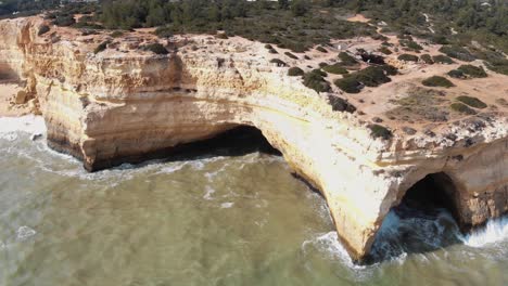 Marinha-Strand-Erodierte-Klippen-Im-Dorf-Benagil-An-Der-Algarve,-Portugal---Panoramische-Luftaufnahme-Mit-Niedrigem-Winkel