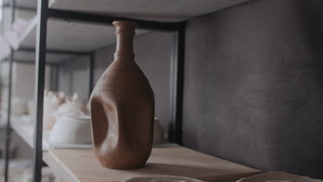 hands shaping a clay vase