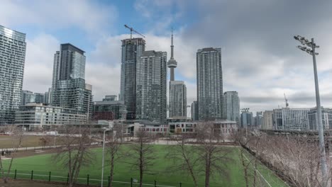 Soccer-Field-Backdropped-By-Developing-Highrises-And-Famous-CN-Tower-In-Toronto,-Canada