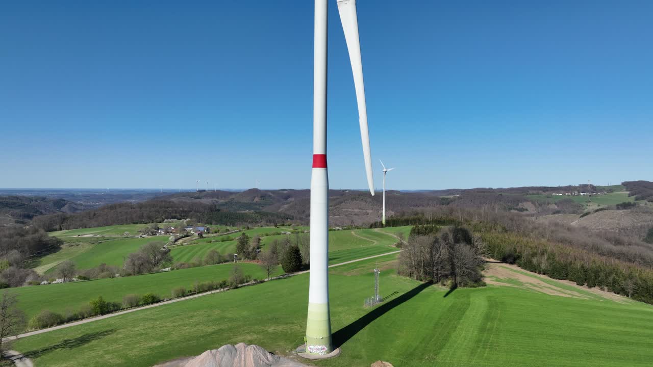 Clean eenrgy production, power from the wind, electricity, renewable energy, wind power, wind turbines in green landscape. Aerial view. close up.