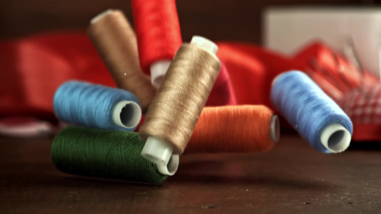 Colorful Thread Spools Falling in Slow Motion