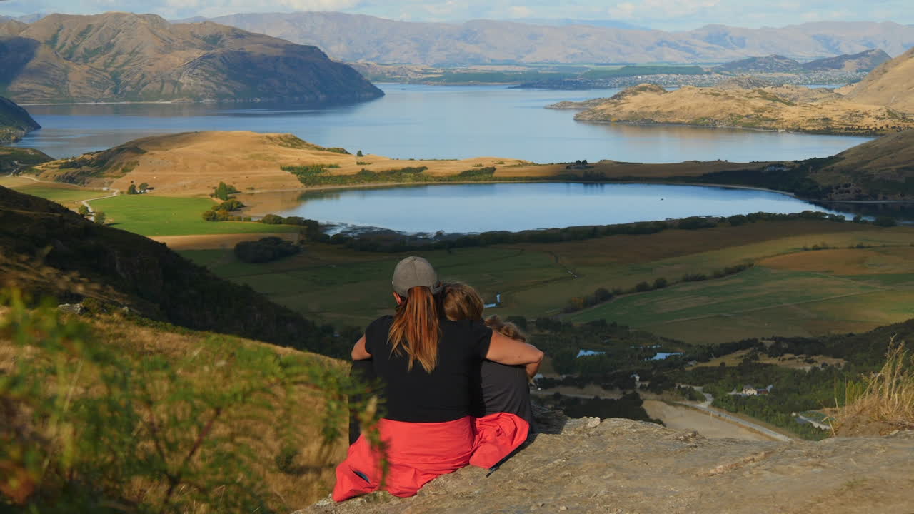 Family enjoying scenic view of lake and mountains
