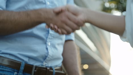 footage of two interviewers and one applicant shaking hands consecutively