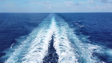 a breathtaking view of a sailboat gliding through deep blue ocean waves, with the endless horizon stretching ahead. the rhythmic motion of the water