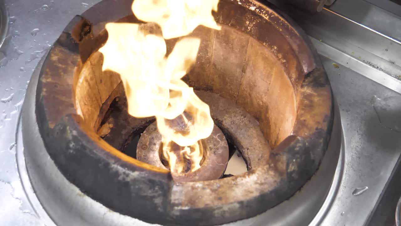 Slow-motion capture of a gas fire igniting, with flames bursting to life in mesmerizing detail, illustrating the raw power and beauty of combustion.