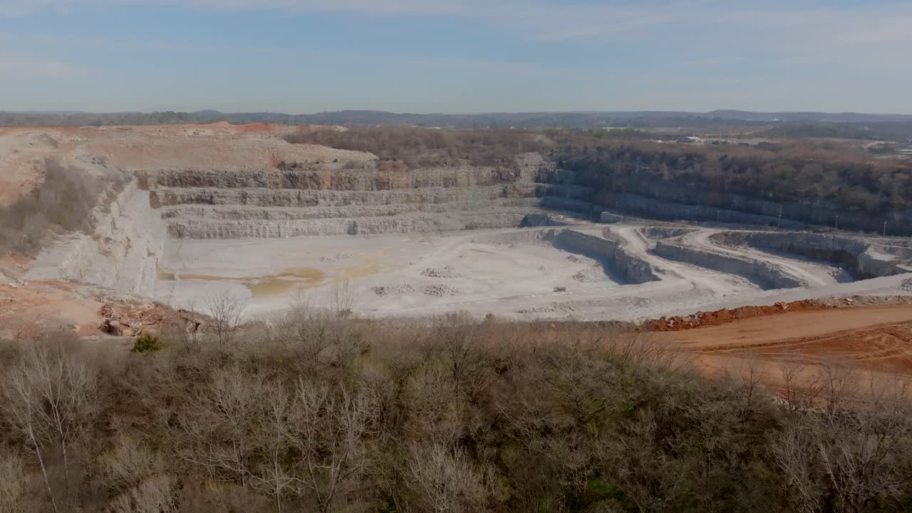 Wide aerial footage of a large quarry in Chattanooga, TN in the light of the afternoon.