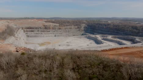 wide aerial footage of a large quarry in chattanooga, tn in the light of the afternoon.
