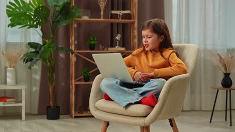 girl surprised by something on a laptop