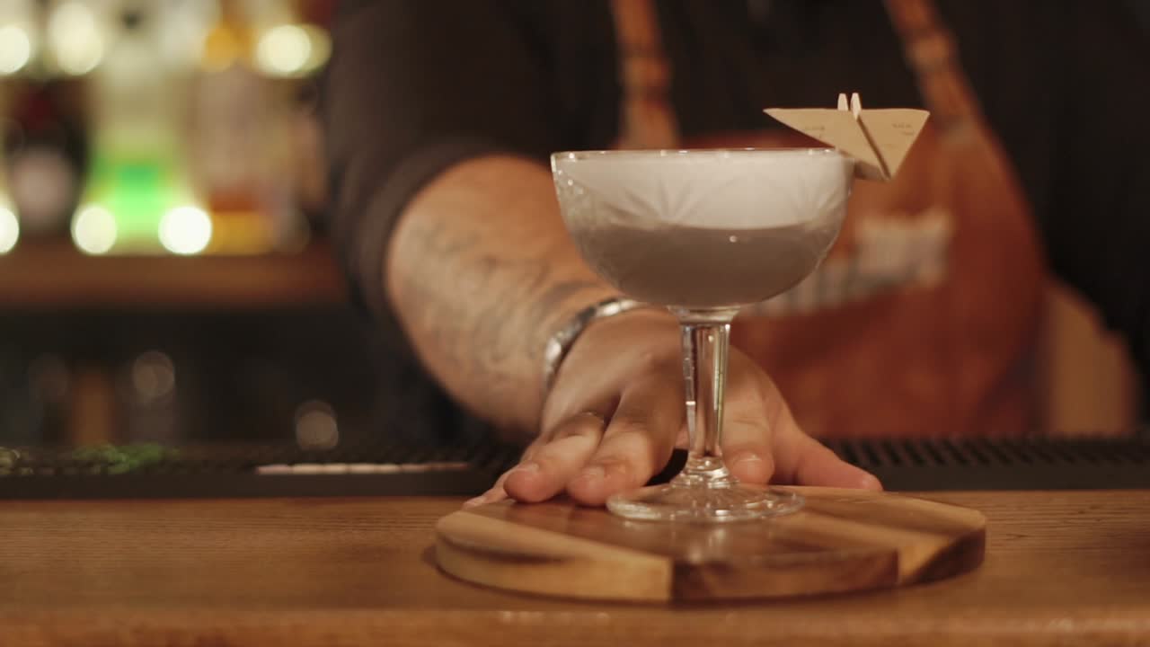 camarero sirviendo un cóctel en un bar