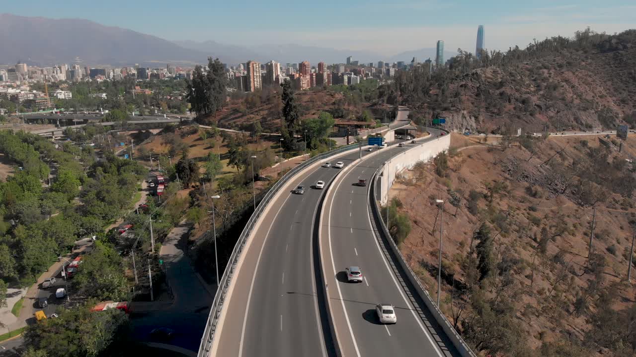 Aerial flying over Highway with traffic with the Santiago Skyline on the background, 4K