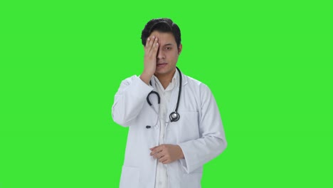 tensed indian doctor working long hours green screen